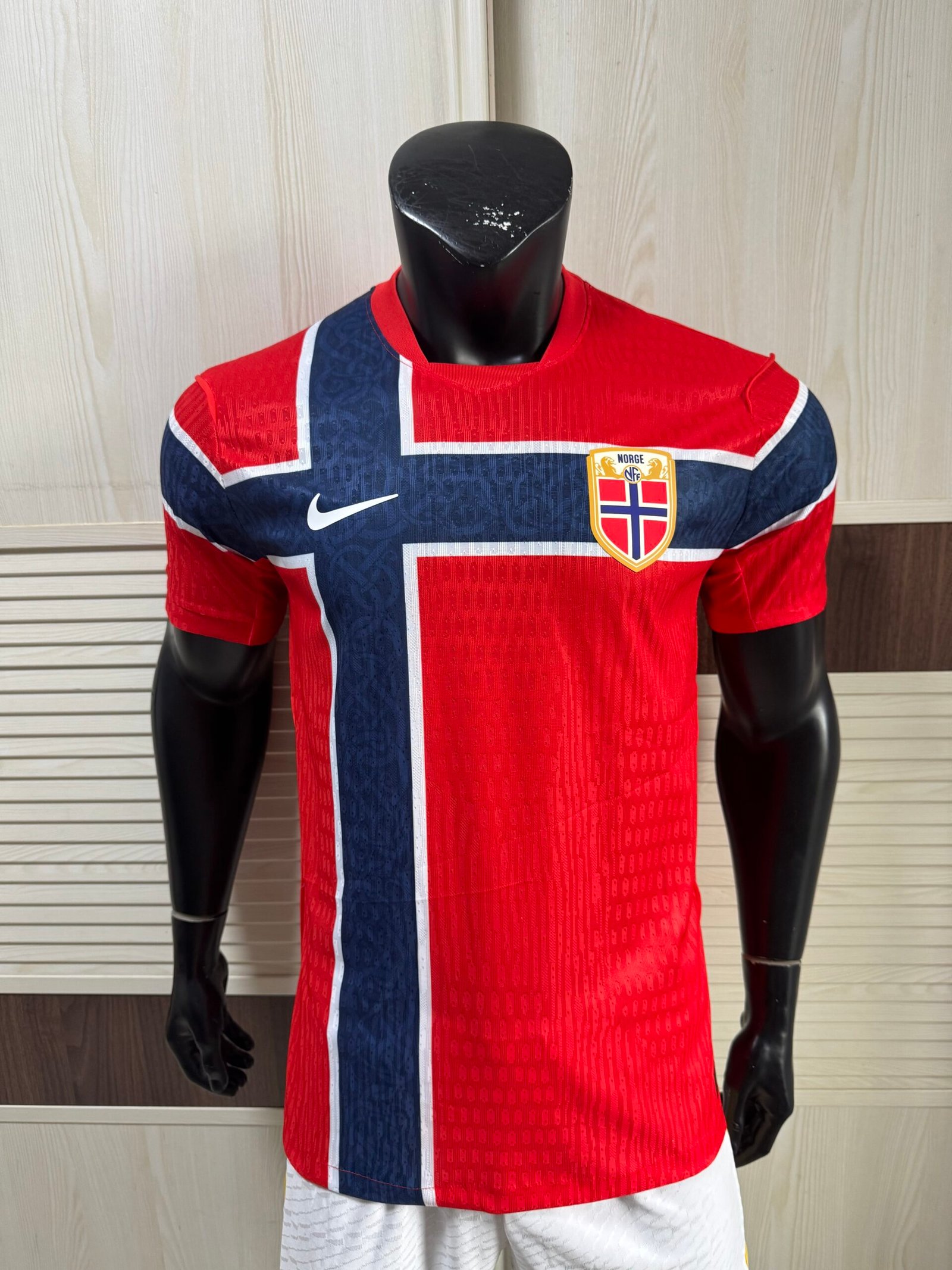 Nike Norway 2026 World Cup Home Jersey front view showing striking Chile red official Norwegian shirt with flag-inspired cross design and Nike Aero-FIT fabric texture
