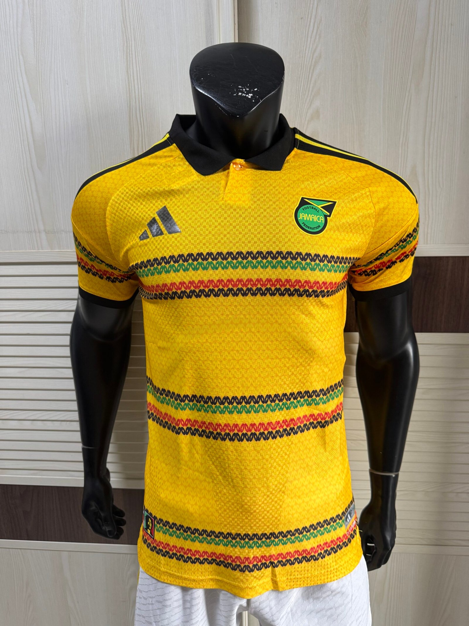 Adidas Jamaica 2026 x Bob Marley Home Authentic Jersey bold gold Reggae Boyz official kit front view showing iconic Bob Marley tribute design and authentic Jamaican football shirt